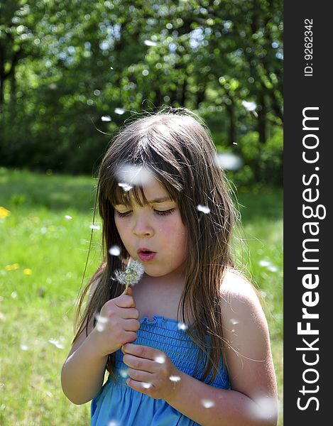 Little girl closeup portrait with dandelion