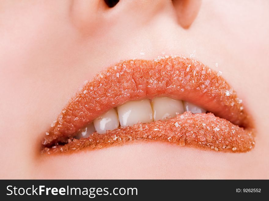 Woman's red lips coated with scattered sugar. Woman's red lips coated with scattered sugar