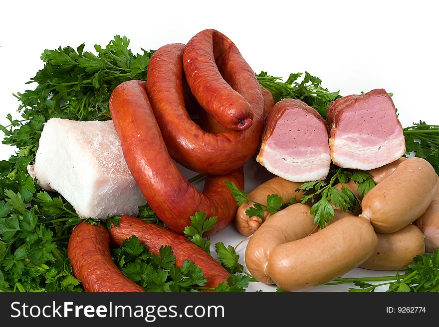 Sausage wares on a background greenery, studio shot