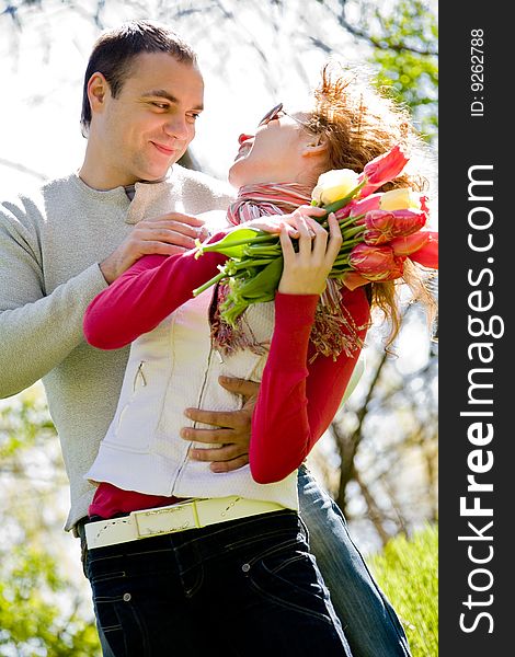 Happy young couple with red tulips. Happy young couple with red tulips