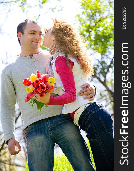 Happy young couple with red tulips. Happy young couple with red tulips
