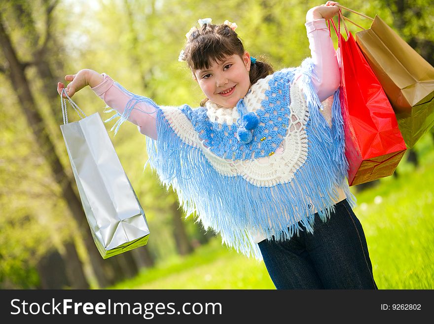 Cute little girl with shopping bags
