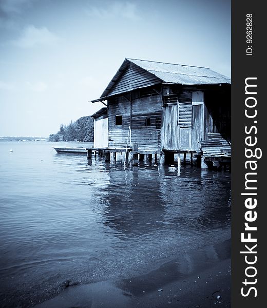 A old house on the waters in ubin island, in selenium tone