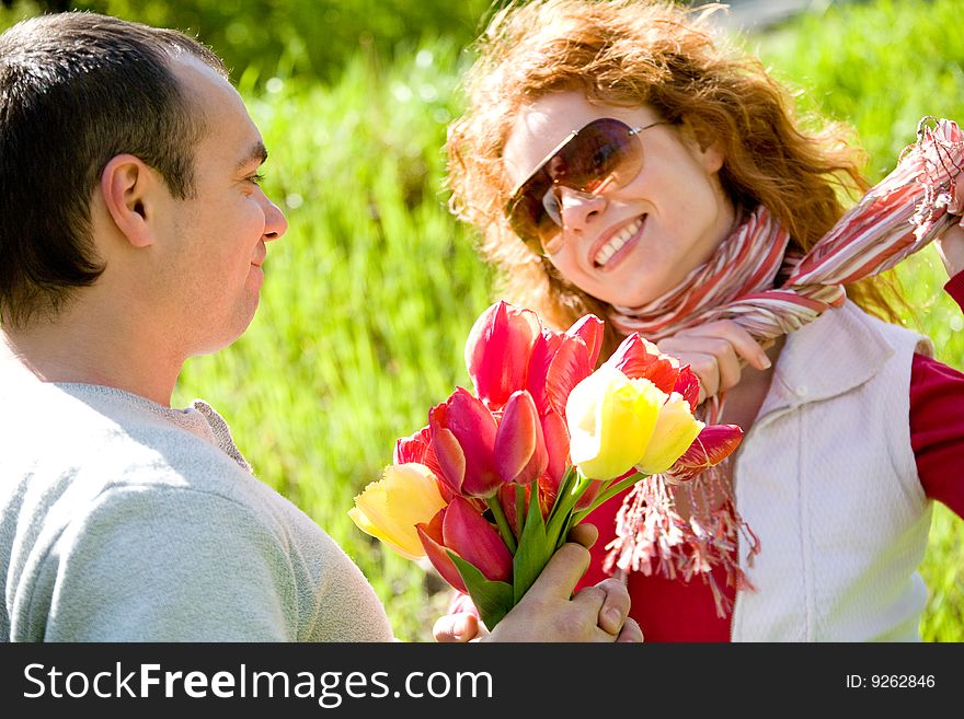 Happy young couple with red tulips. Happy young couple with red tulips