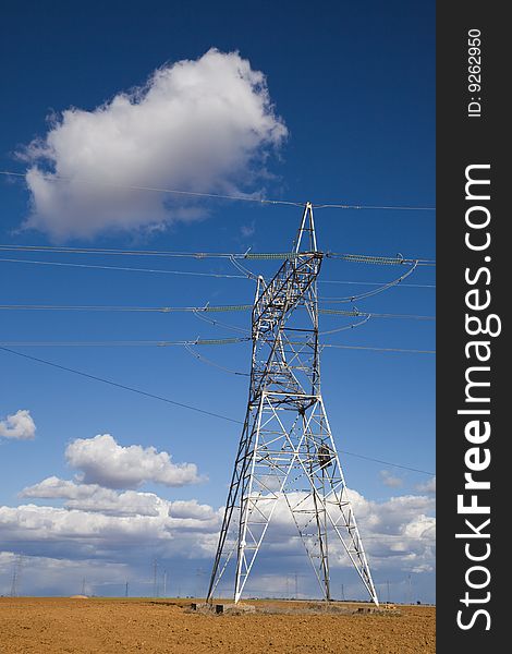 Electricity pylon against blue sky