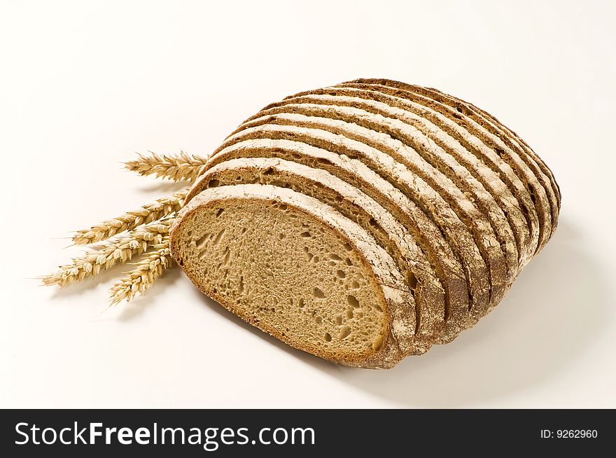 Sliced loaf of continental bread and wheat eats. Sliced loaf of continental bread and wheat eats