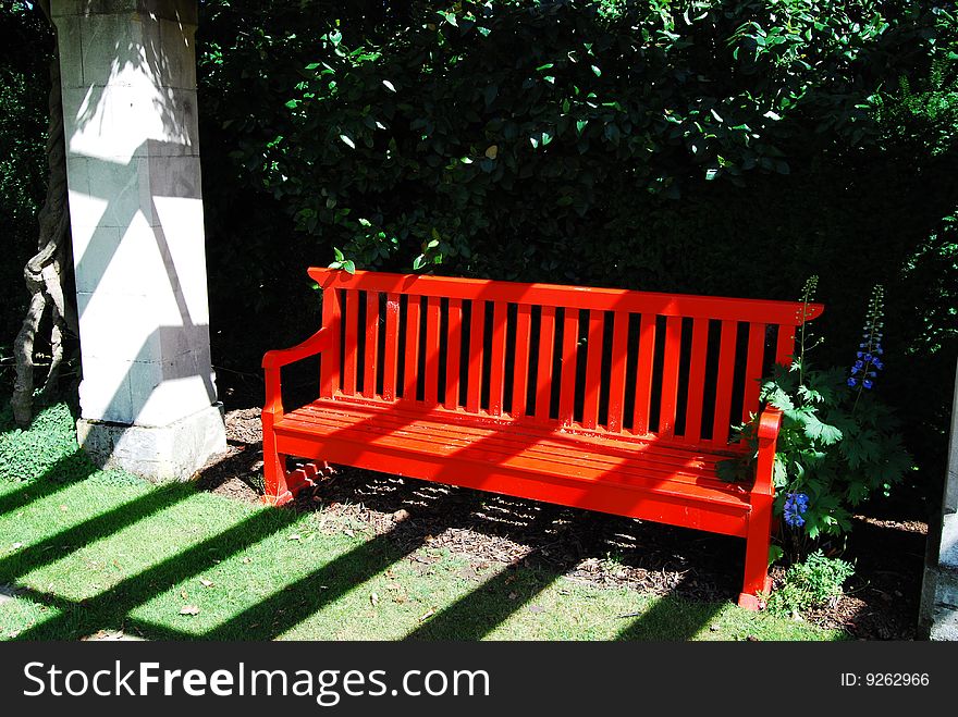 Bright red bench in the park