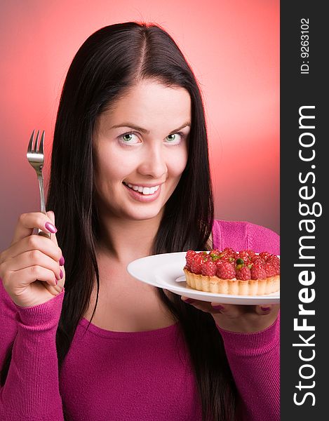 Young beautiful woman preparing to eat raspberry cake. Young beautiful woman preparing to eat raspberry cake