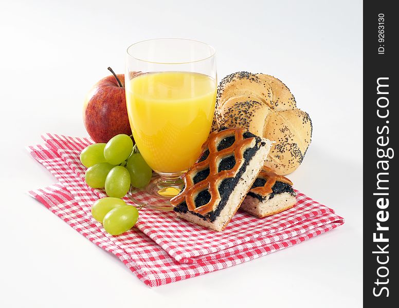 Still life of a glass of juice, pastry and fruit. Still life of a glass of juice, pastry and fruit