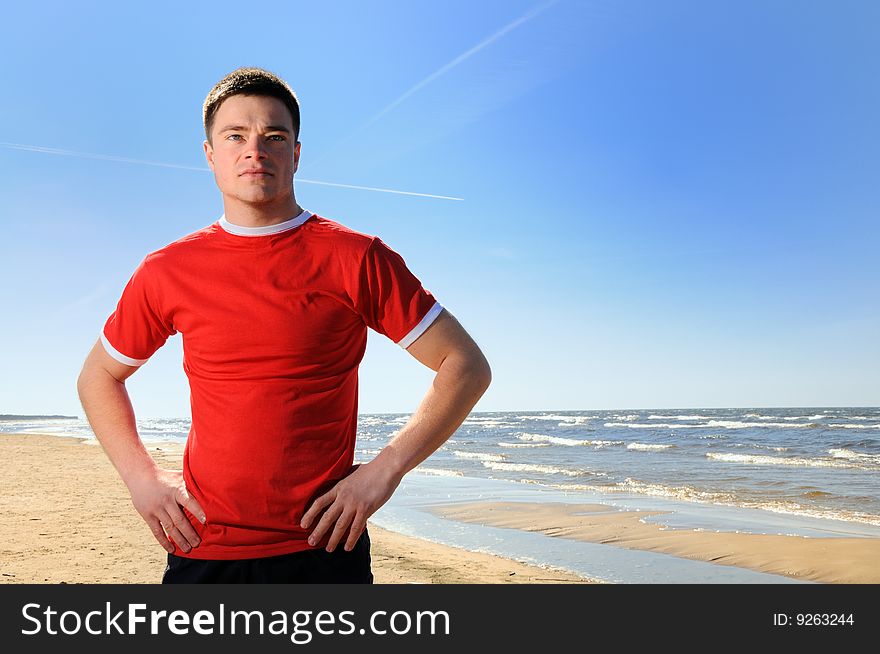 Young man standing at beach