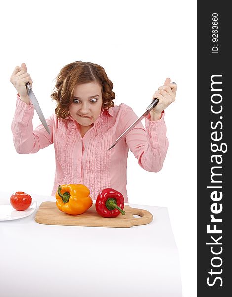 Beautiful young woman with fresh vegetables. Pretty girl with pepper.  Housewife with sweet peppers and knifes. Isolated over white background. Beautiful young woman with fresh vegetables. Pretty girl with pepper.  Housewife with sweet peppers and knifes. Isolated over white background.