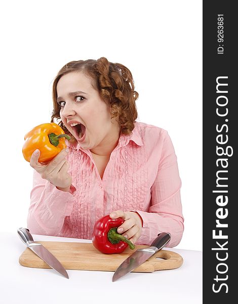 Woman wants to eat sweet peppers. Pretty smiling girl is holding sweet pepper.  Housewife with sweet peppers and knifes. Isolated over white background. Woman wants to eat sweet peppers. Pretty smiling girl is holding sweet pepper.  Housewife with sweet peppers and knifes. Isolated over white background.