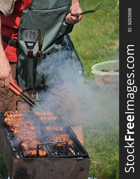 Man grilling some barbecue stuff. Man grilling some barbecue stuff