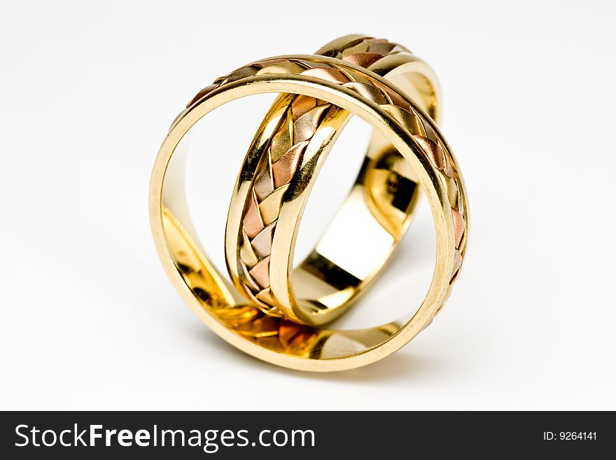 Two gold rings, are photographed on a white background. Two gold rings, are photographed on a white background