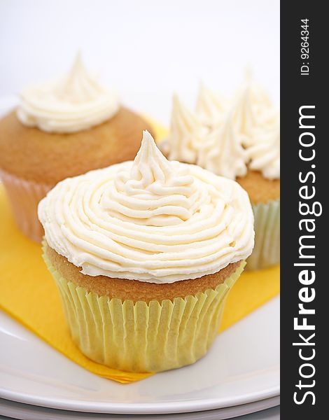 Trio of yummy lemon cupcakes topped with fresh buttercreme frosting