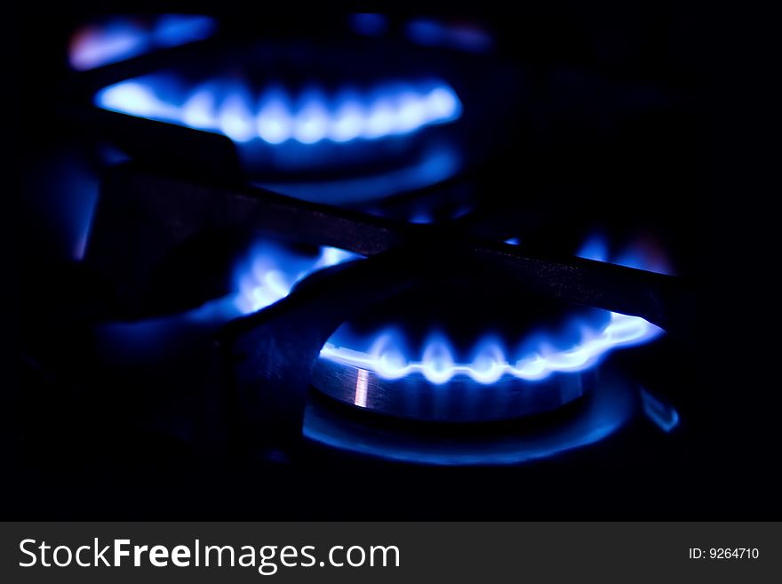 Blue flame of gas stove on black background. Blue flame of gas stove on black background