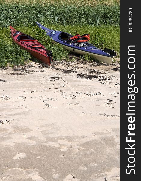 Two Kayaks pulled out of the water onto the sandy dunes, Cape Breton, Canada. Two Kayaks pulled out of the water onto the sandy dunes, Cape Breton, Canada.