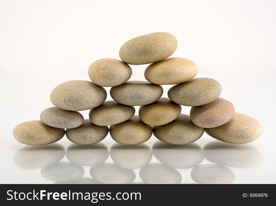 Pebble pyramid on white background