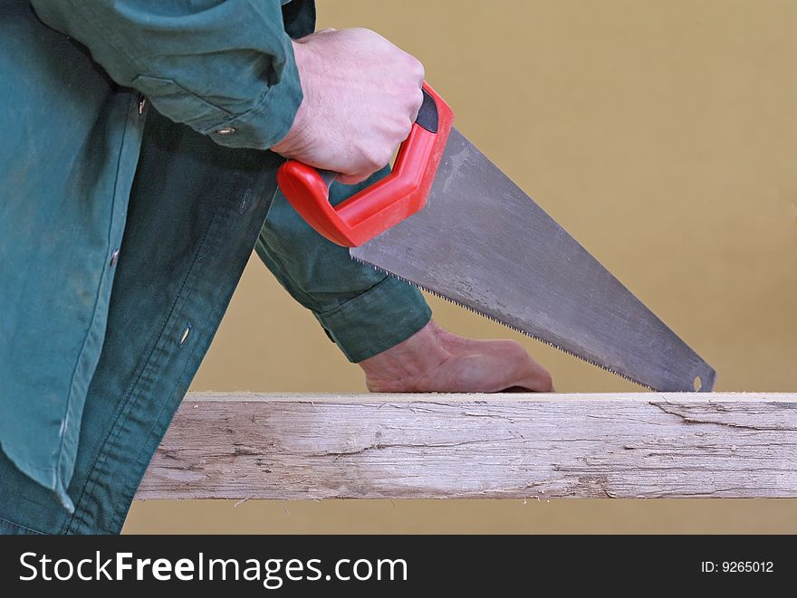 Arm With Handsaw Cutting Wood