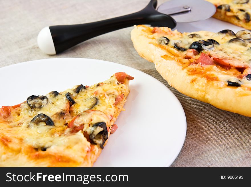 Fresh Pizza On A White Plate And A Linen Cloth