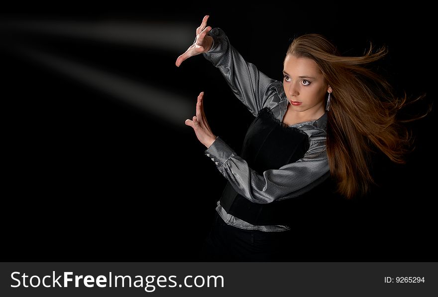 Young girl  and two beams of light in dark