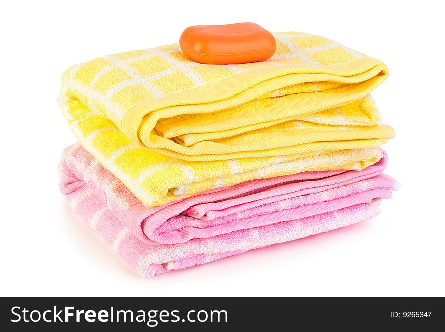 Towels and piece of soap isolated on white background. Towels and piece of soap isolated on white background