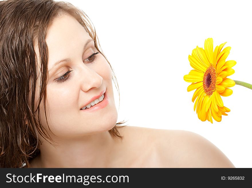 Smiling beautiful woman looking to yellow gerber. Smiling beautiful woman looking to yellow gerber