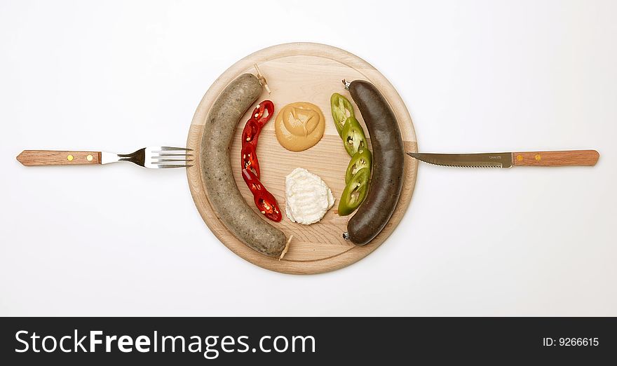 A wooden plate full of sausage 2