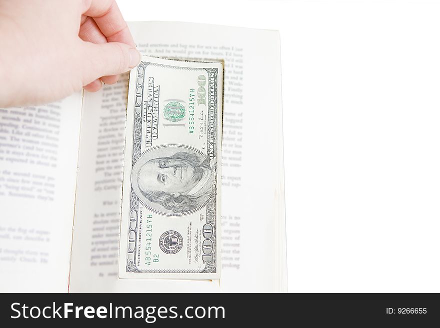 Hand taking one hundred dollar bill from prop book. Hand taking one hundred dollar bill from prop book