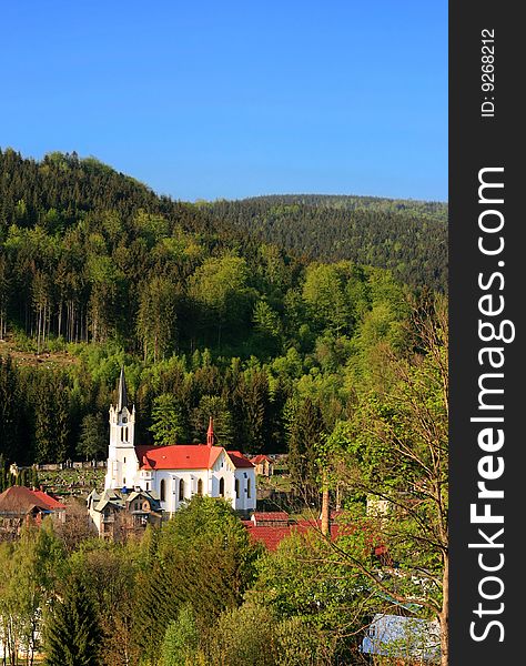 A little church in a mountain village in spring. A little church in a mountain village in spring