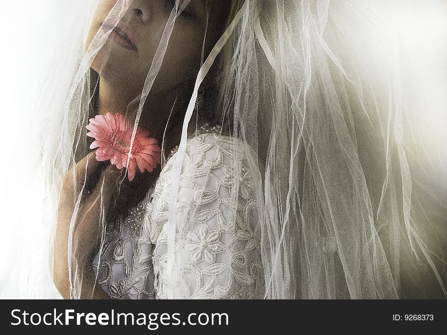 Bride with wedding dress and pink flower