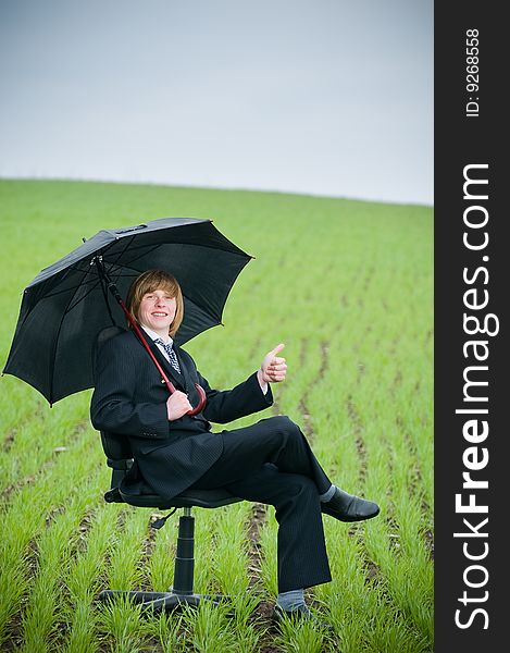 Smiling businessman with umbrella