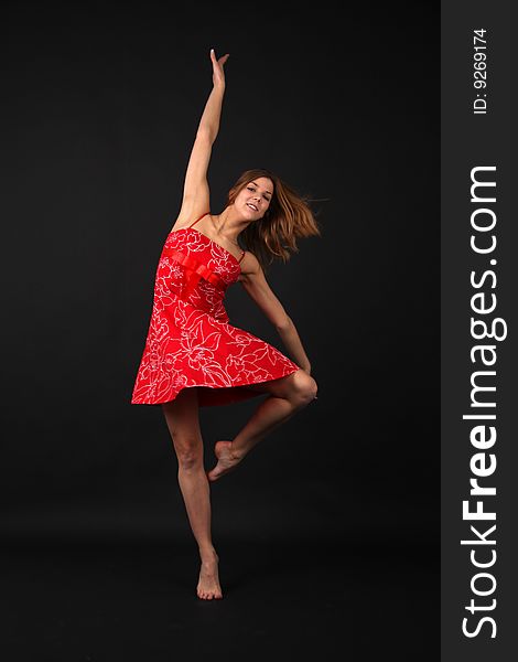 Elegant young flexible woman in red-white outfit