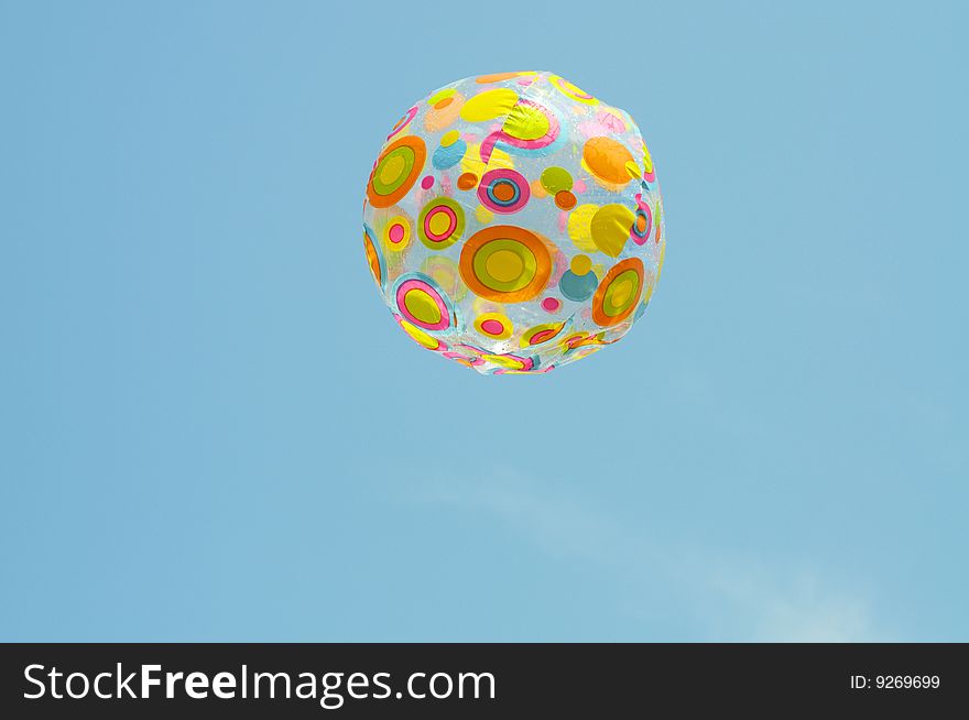 Multicolored ball against a background of blue sky. Multicolored ball against a background of blue sky