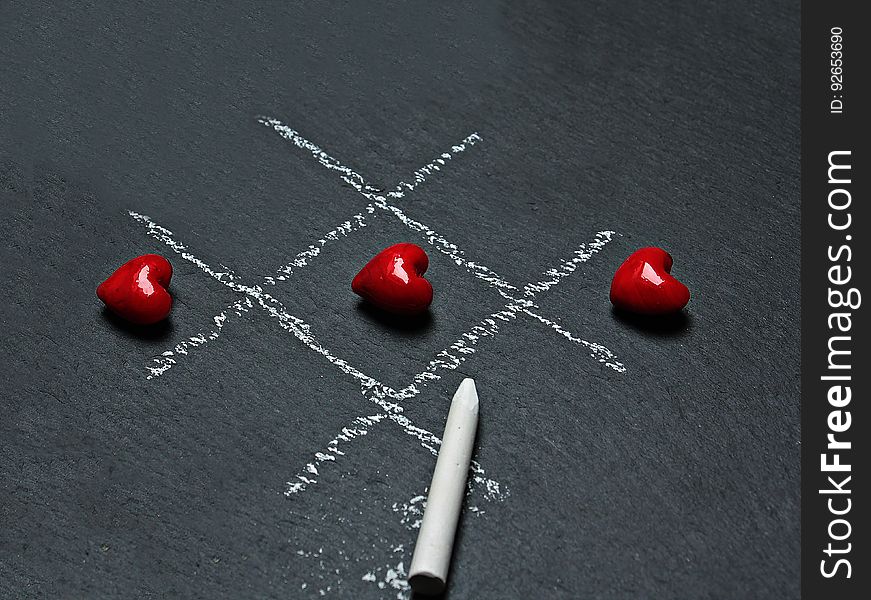 A winning game of tic tac toe played with heart shaped objects. A winning game of tic tac toe played with heart shaped objects.