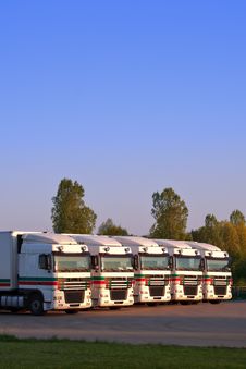 Five Trucks In A Row With Trees And Blue Sky Stock Photos Five Trucks In A Row With Trees And Blue Sky Stock Photos