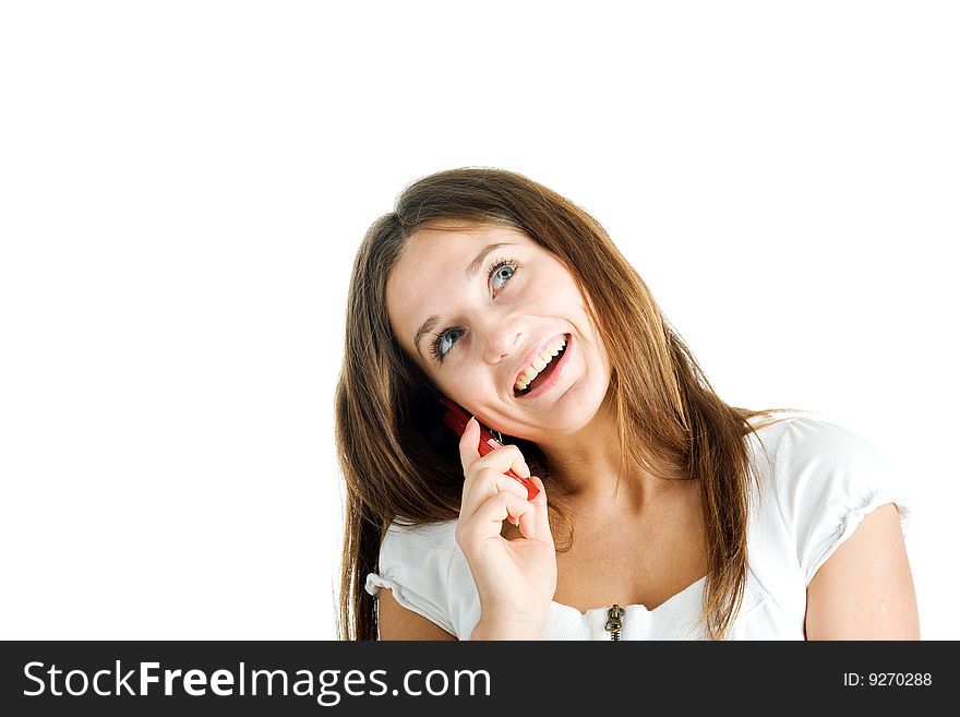 A smiling beautiful young woman in a white dress speaking by mobile phone. A smiling beautiful young woman in a white dress speaking by mobile phone