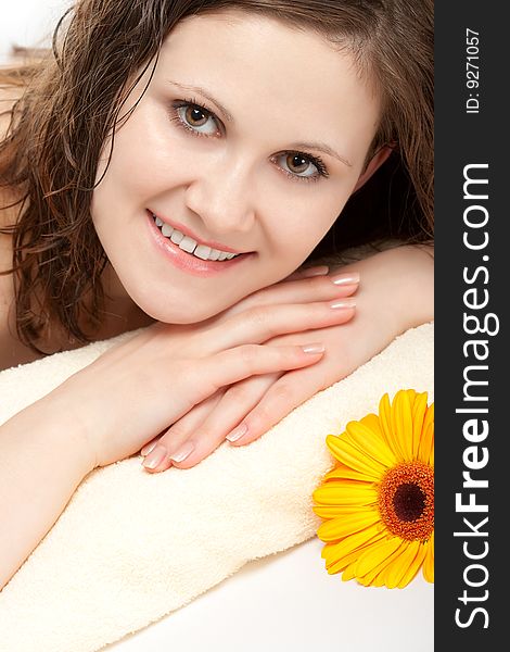 Smiling woman laying on the yellow terry towel. Smiling woman laying on the yellow terry towel