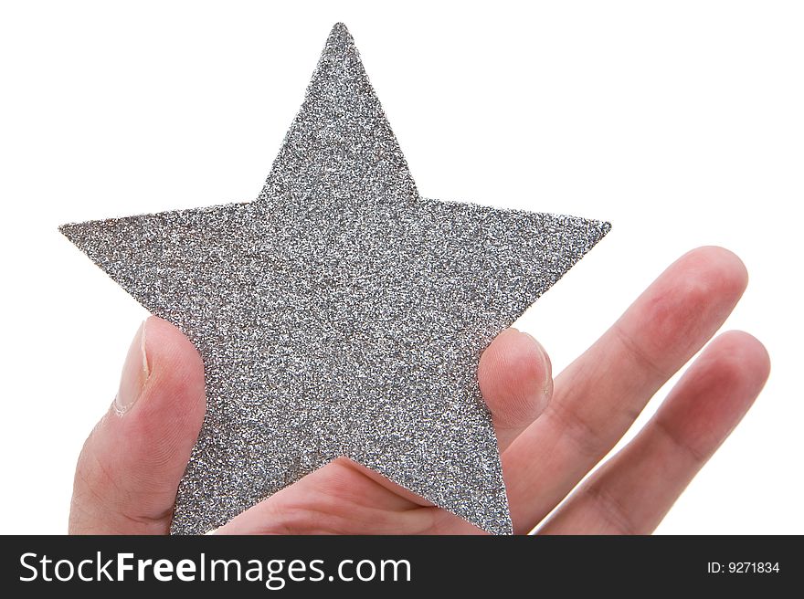 Silvery star in a hand isolated on a white background