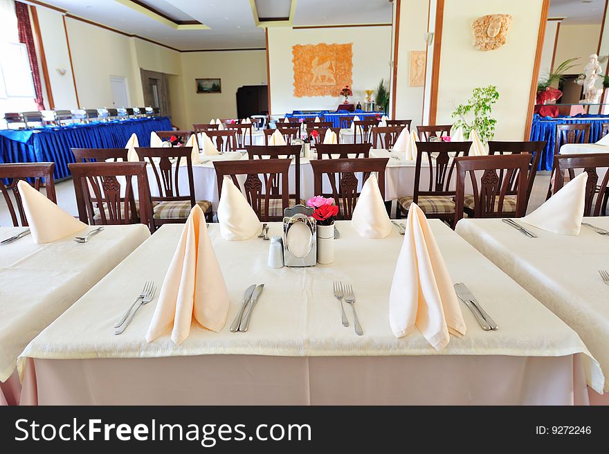 Empty cafe with silverware on a tables