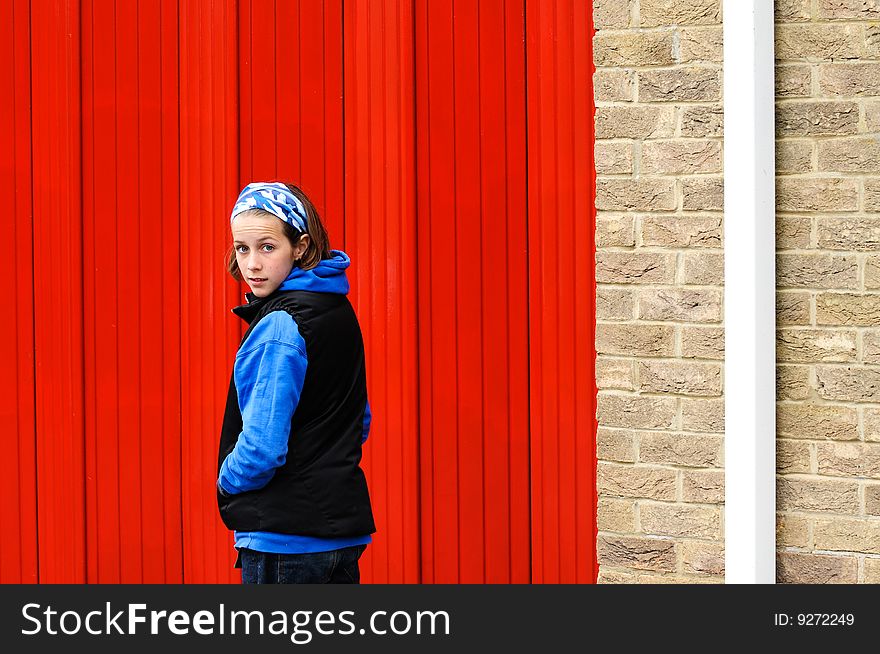 Teenage Girl By Red Wall