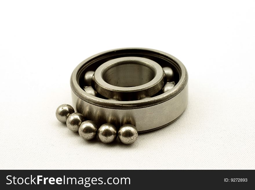 The bearing and spheres, is photographed on a white background. The bearing and spheres, is photographed on a white background