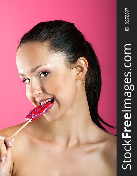 Smiling woman with a lollipop