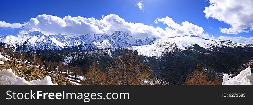 Scenic view of snow capped Meili mountain with cloudscape in foreground, Yunnan province, China. Scenic view of snow capped Meili mountain with cloudscape in foreground, Yunnan province, China.