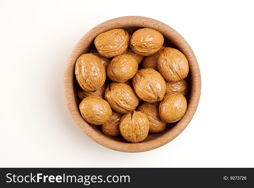 Bowl of walnuts isolated on white