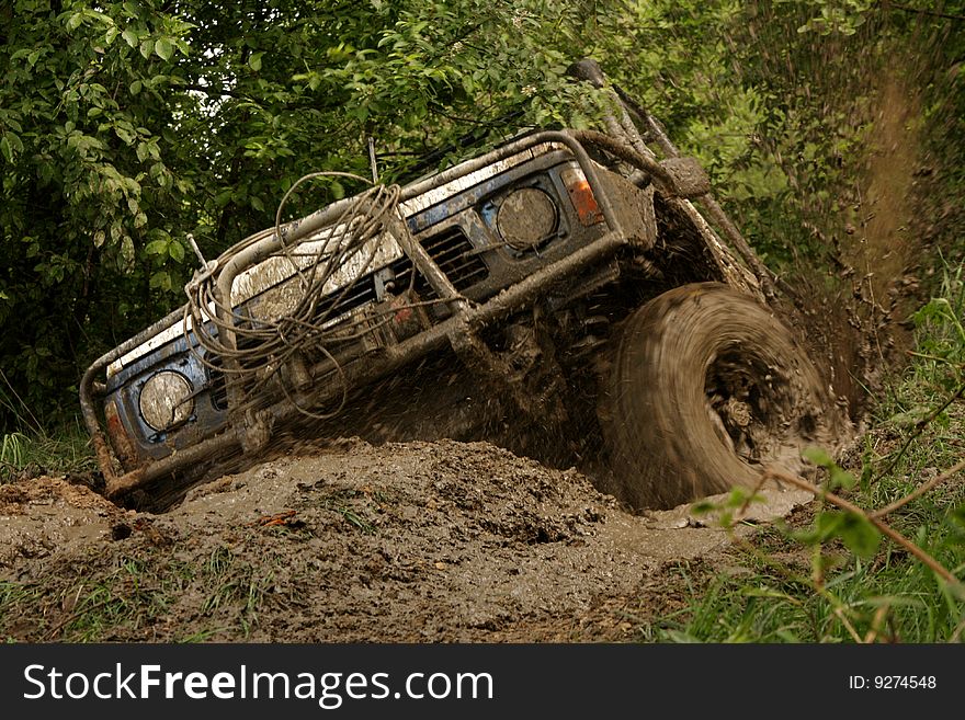 The vehicle jumping and splashing out the mud. The vehicle jumping and splashing out the mud