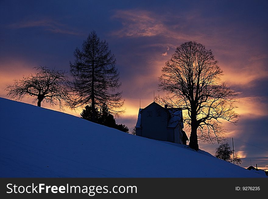 Landscape in Appenzell (Switzerland) in the evening during the winter with snow in the front. Landscape in Appenzell (Switzerland) in the evening during the winter with snow in the front