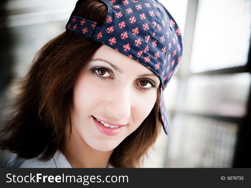 Dark Haired Girl With Baseball Cap. Close-Up Portrait