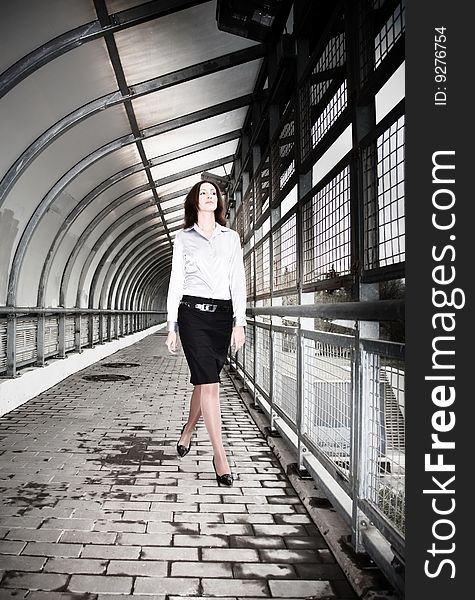 Beautiful Businesswoman Walking On The Pedestrian Bridge.