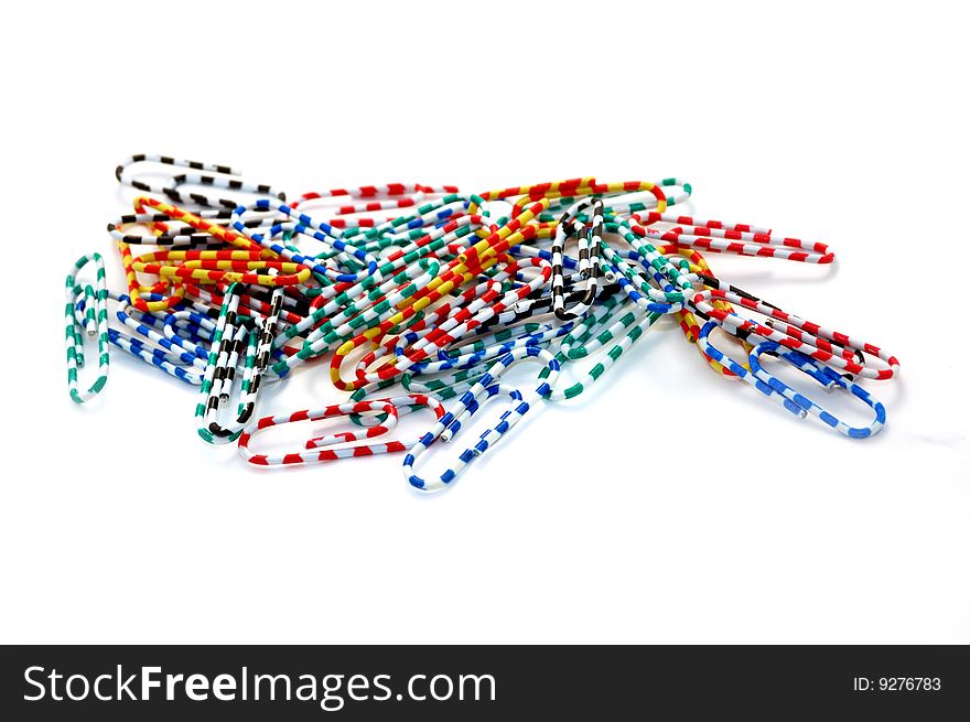 Colored paperclips on white background
